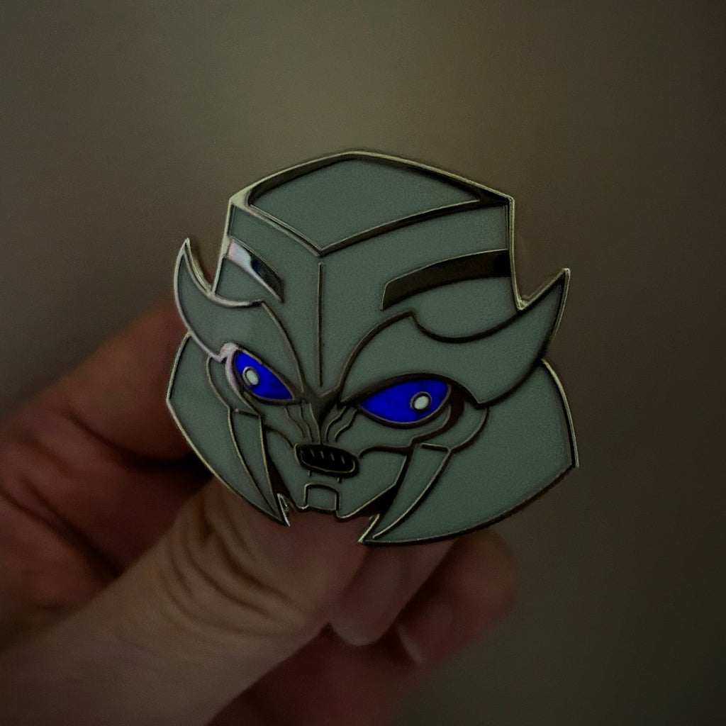 Godliath TFP Dark Energon Megatron hard enamel pin with silver metal and glow-in-the-dark blue optics.
