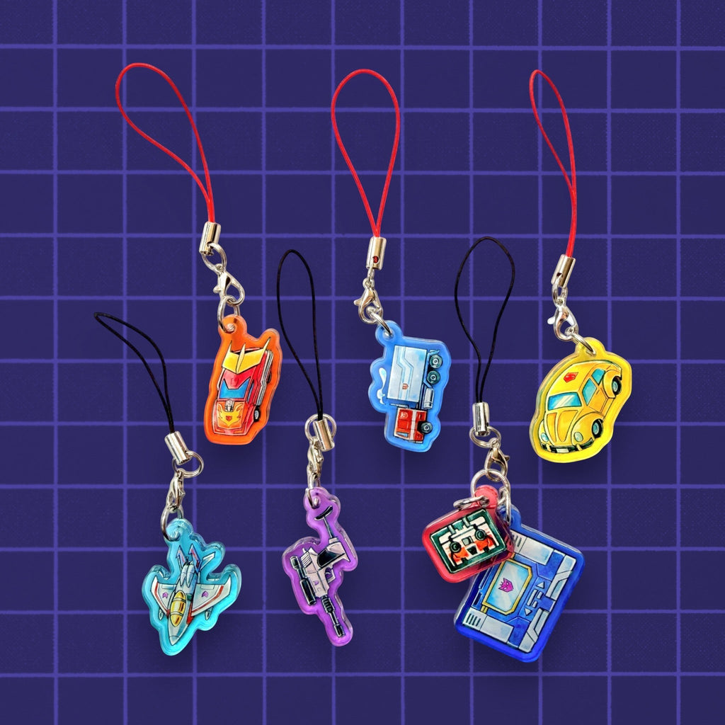 Godliath G1 Alt Mode acrylic phone charms featuring Optimus Prime, Megatron, Bumblebee, and other classic characters.