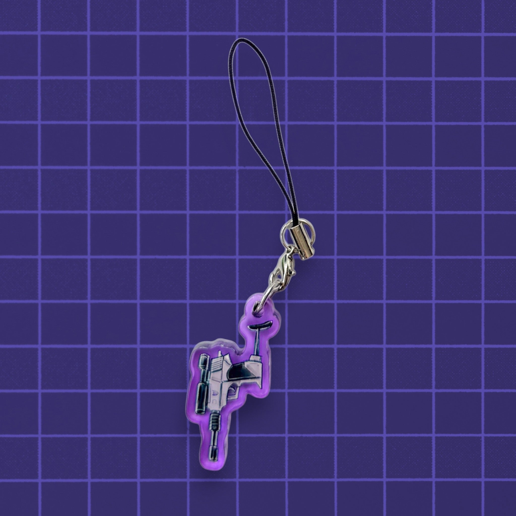 Godliath G1 Alt Mode acrylic phone charm featuring a detailed blaster design on a purple grid background