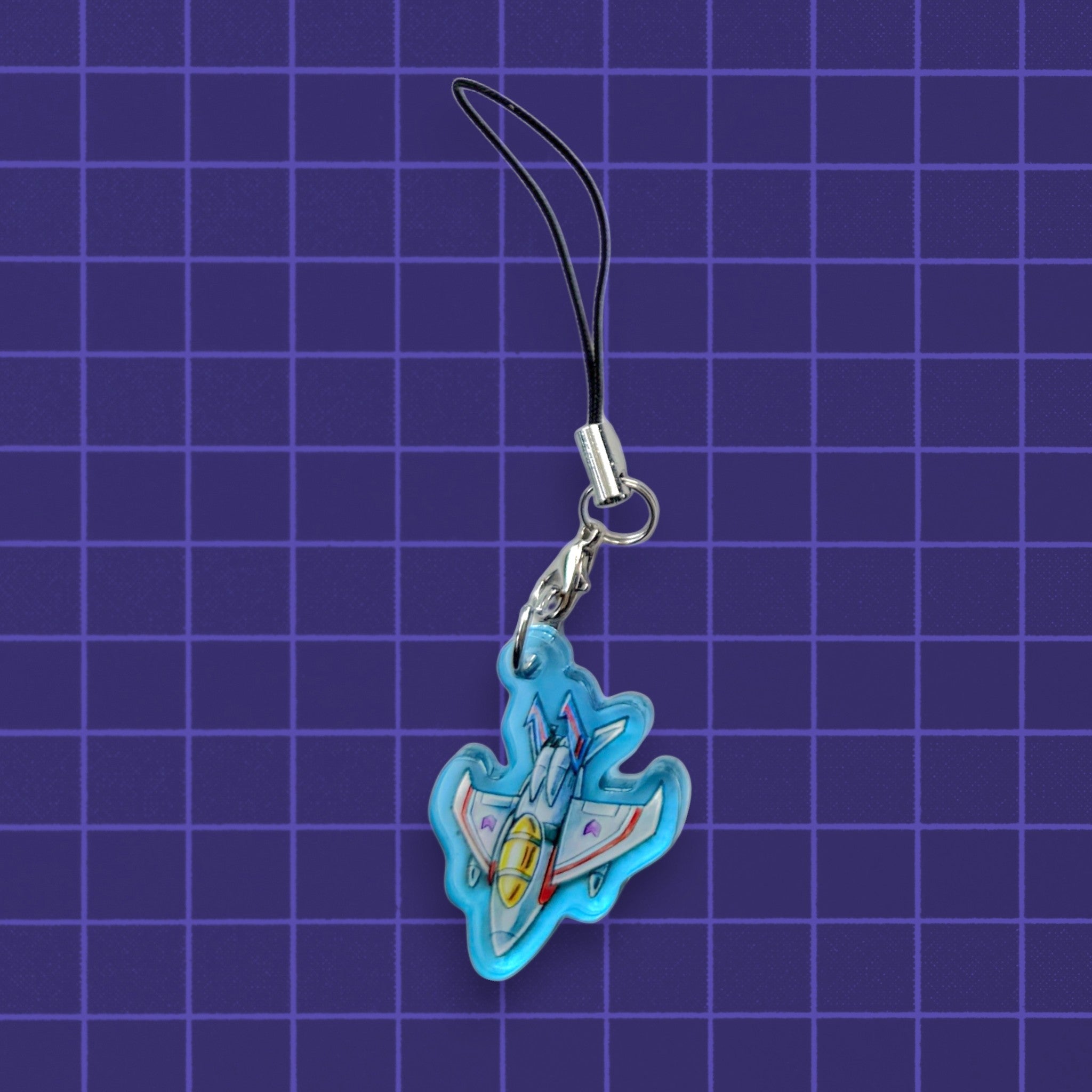 Godliath G1 Alt Mode acrylic phone charm featuring a blue and white fighter jet design on a purple grid background