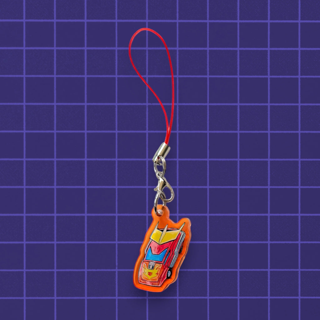 Godliath 1-inch acrylic G1 Alt Mode phone charm featuring a red and yellow sports car design with a red strap.
