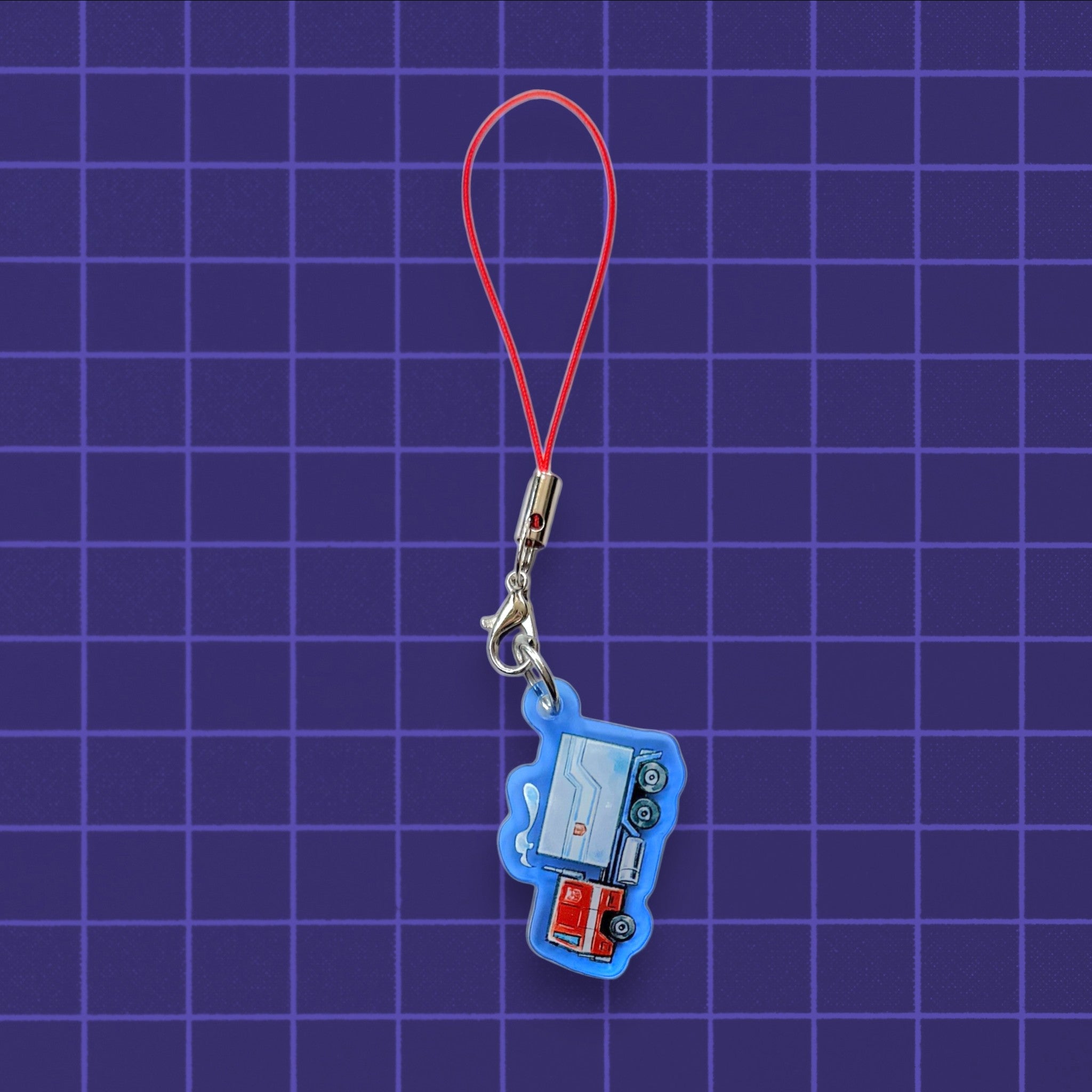 Godliath G1 Alt Mode acrylic phone charm featuring a blue and red truck design with a red cord strap.