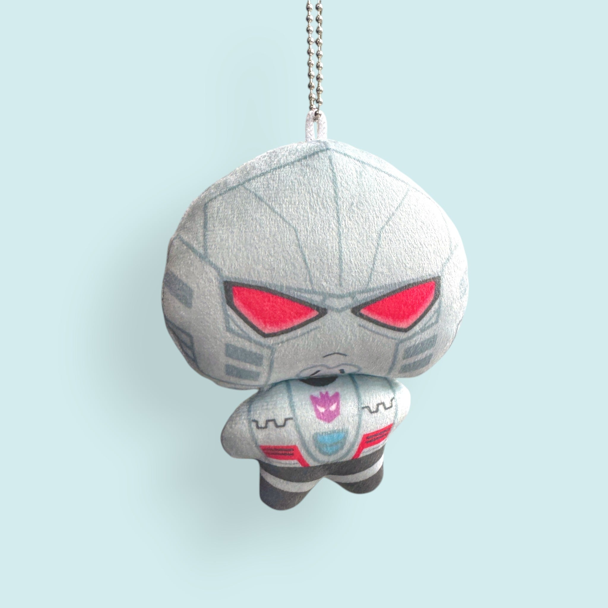 Godliath 4-inch ES MegOp plush charm with silver ball chain, featuring grey robot design and red eyes.