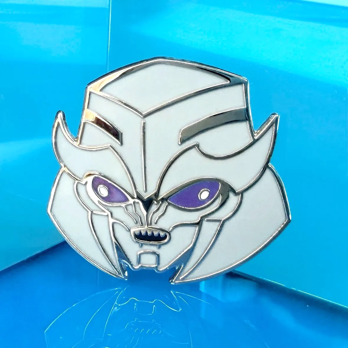 Godliath TFP Dark Energon Megs hard enamel pin with silver metal and glow-in-the-dark purple optics.
