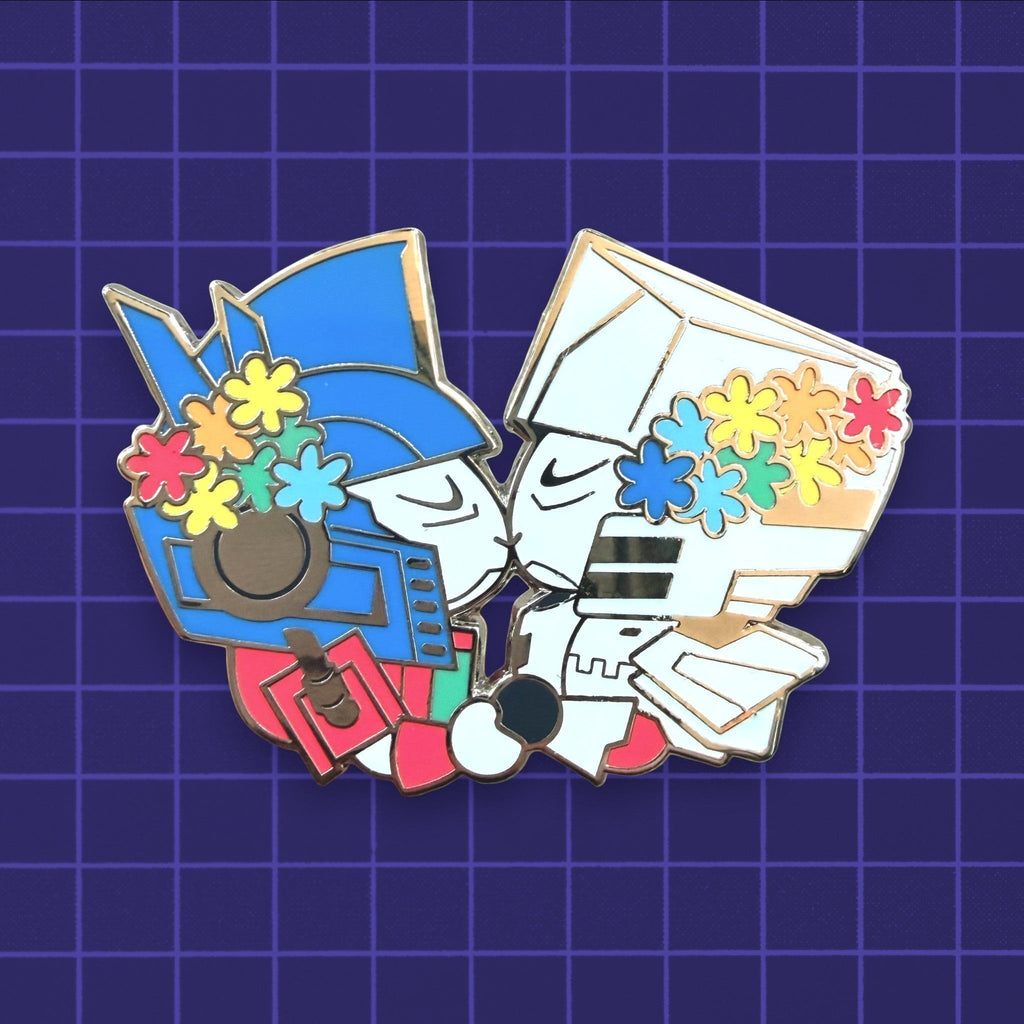 Godliath 2-inch hard enamel wedding pin featuring two robot characters kissing, decorated with colorful flower crowns.