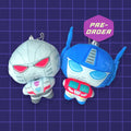 Godliath Transformers plush keychains featuring chibi-style Optimus Prime and Megatron with metal ball chains.