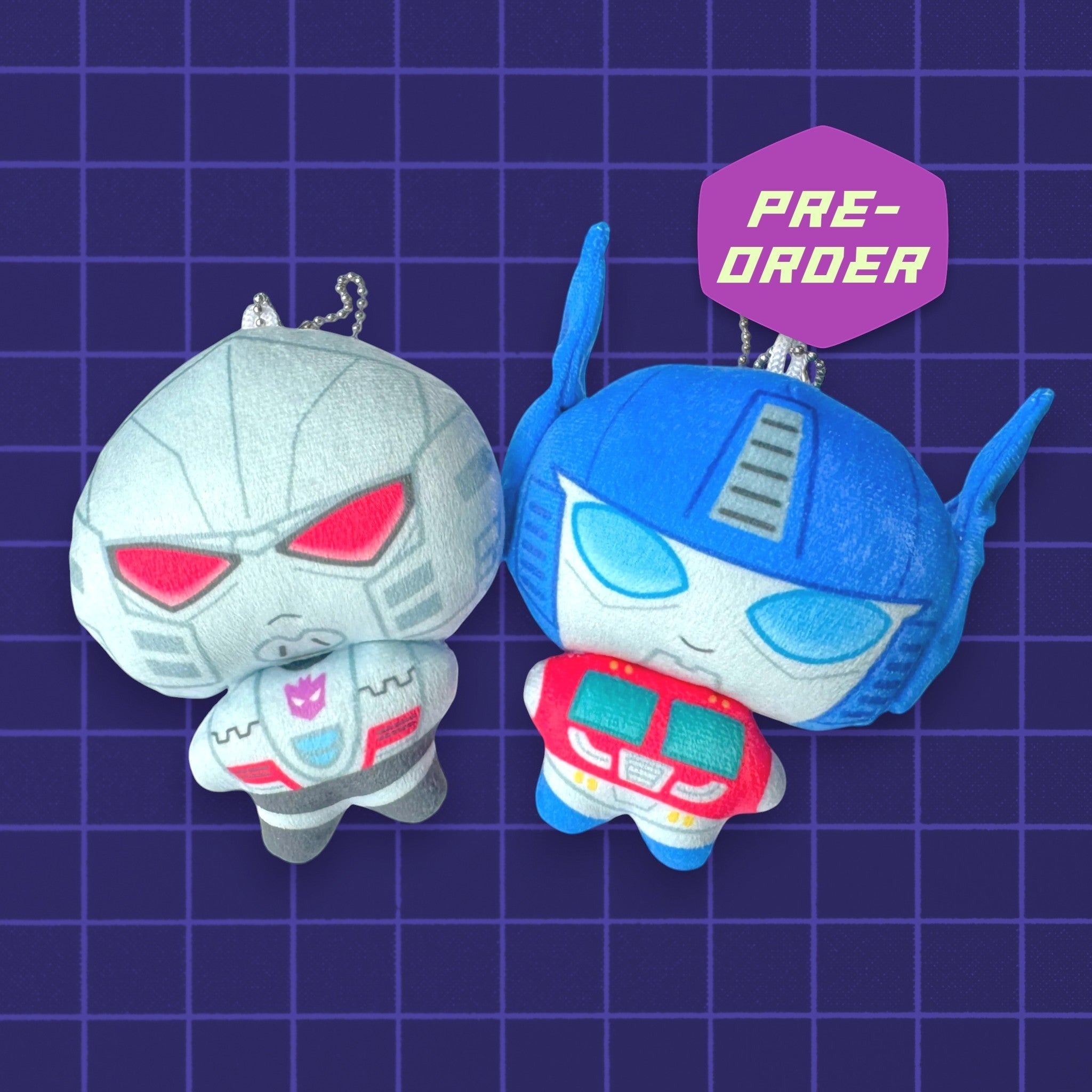 Godliath Transformers plush keychains featuring chibi-style Optimus Prime and Megatron with metal ball chains.