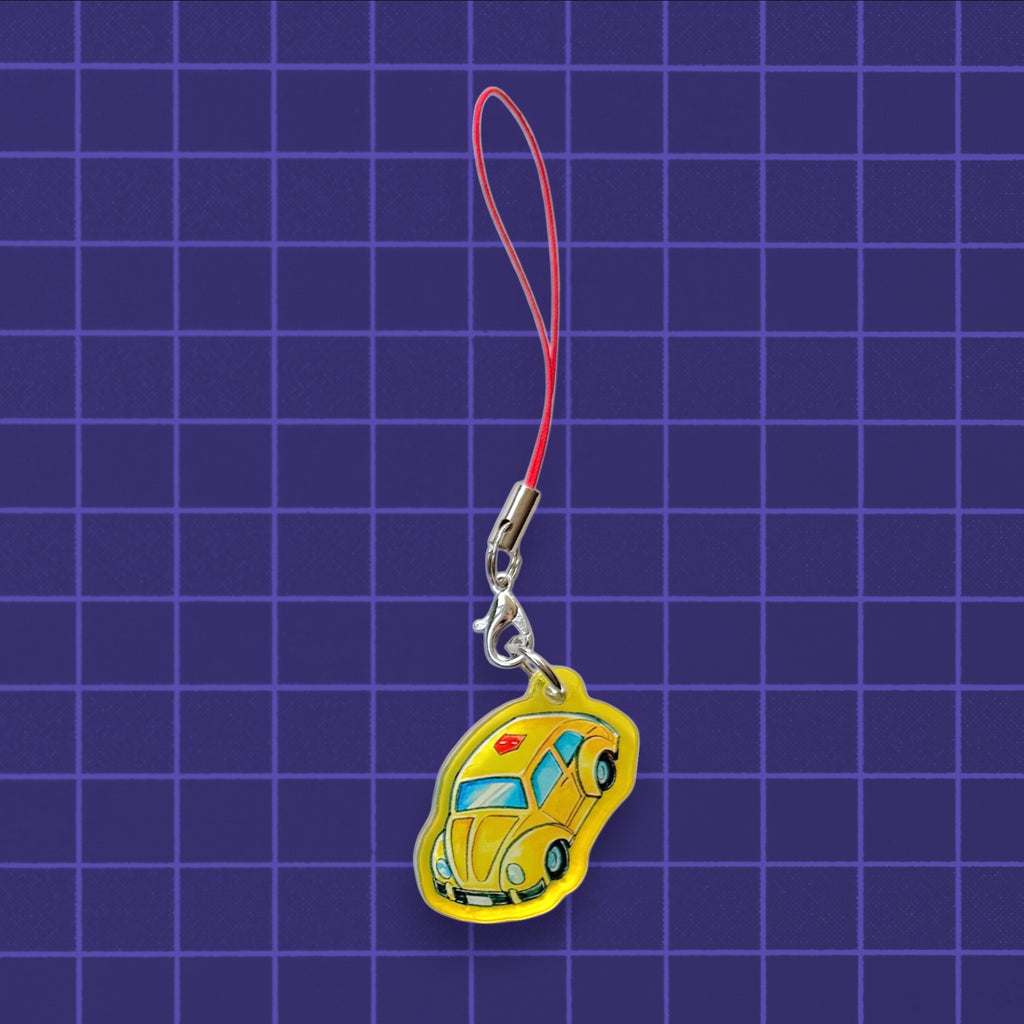 Godliath G1 Alt Mode yellow car acrylic phone charm with a red strap on a purple grid background