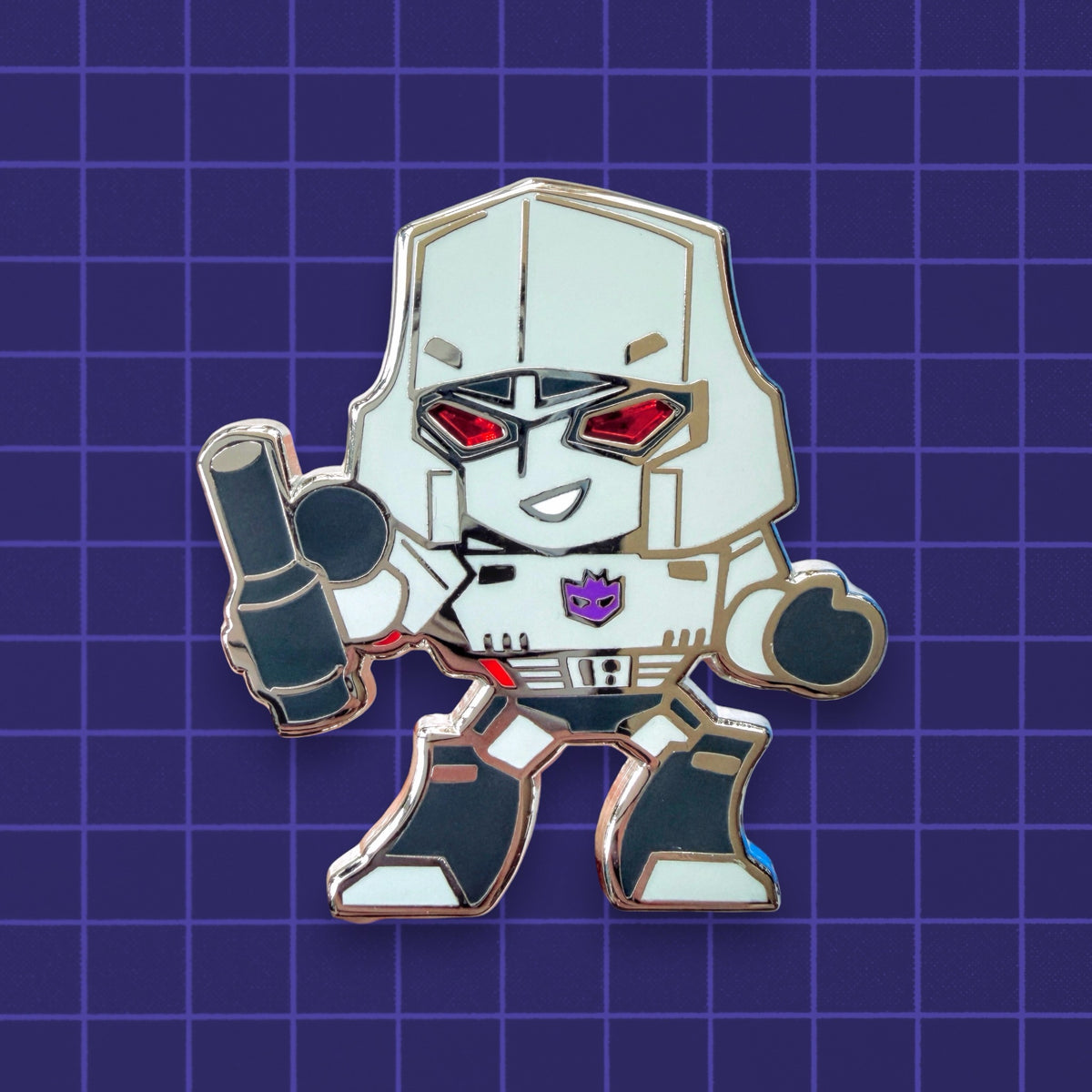 A chibi Transformers Megatron hard enamel pin with translucent enamel eyes